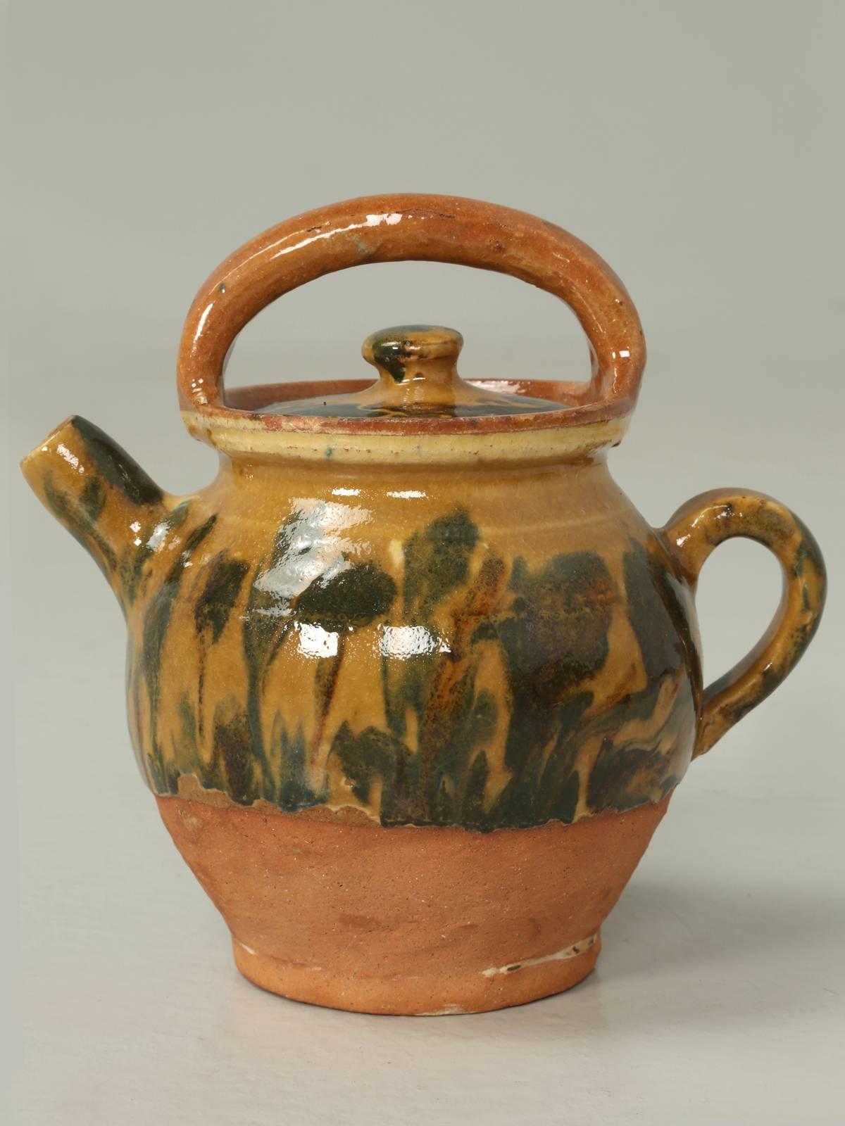 French pottery jug with a non-broken handle and still complete with its original lid. Looks to be circa 1950s and adds a nice touch of French Provence color to any room.
