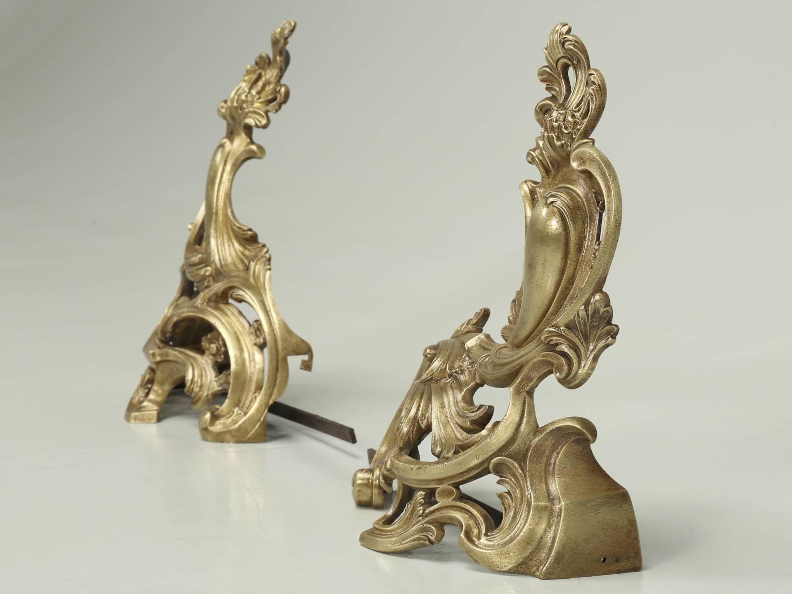 Antique French bronze andirons or chenets, done in a Rococo style from the late 1800s. There are no previous repairs and all they required was a few hours of hand polishing. After which we applied a protective sealer to extend the life of the