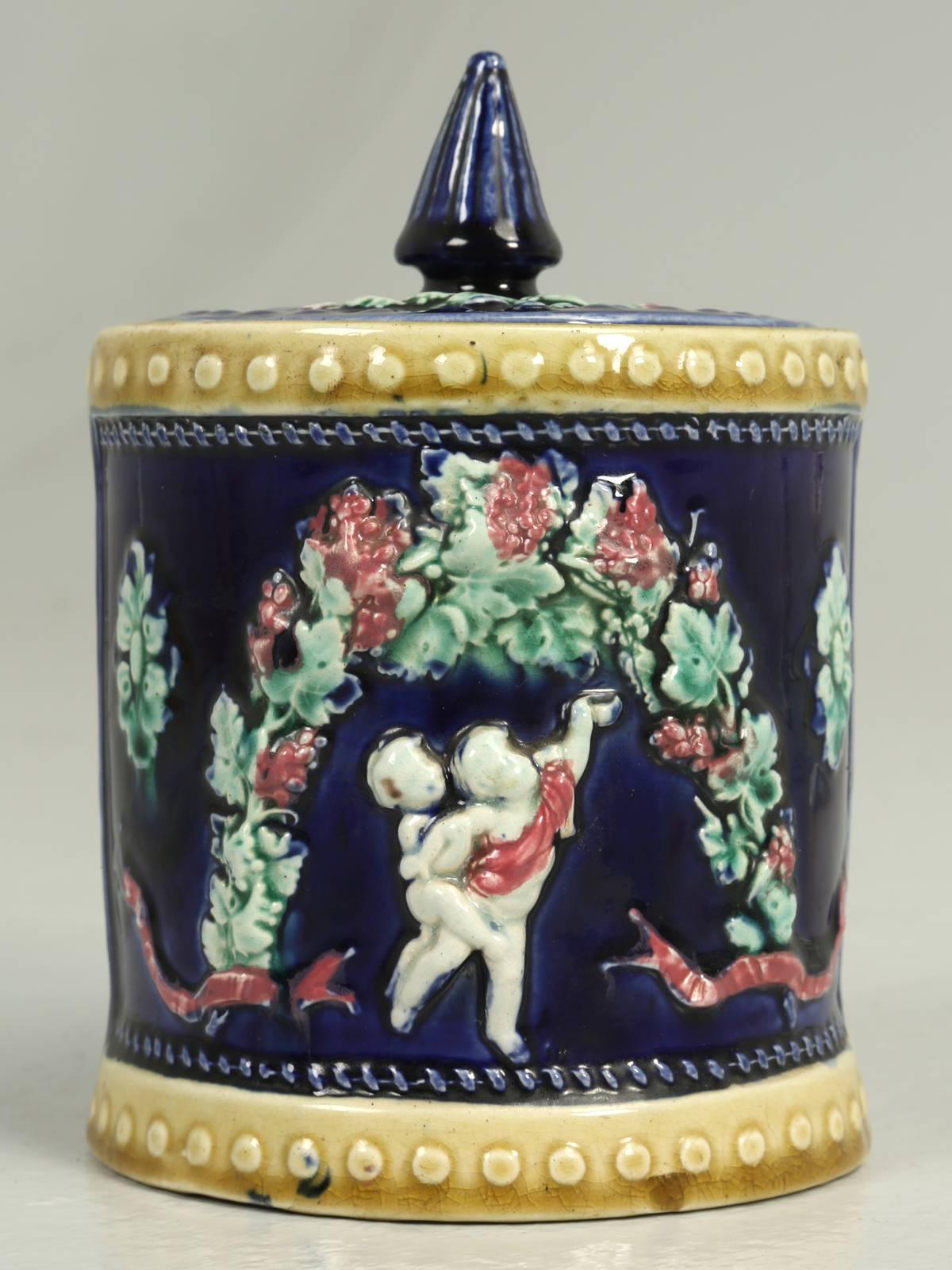 Antique English Condensed Milk Container with its original lid and glazed in a deep rich cobalt blue. Decorated with Putti’s and dates from the 1890s. No visible flaws or prior repairs.