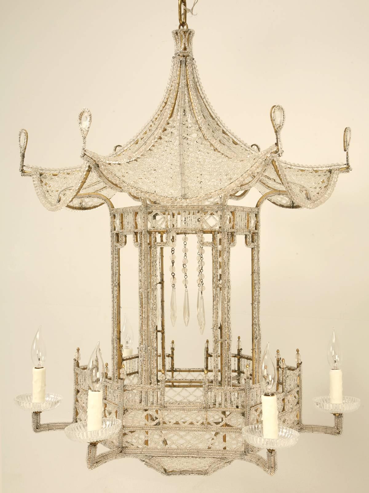 Large, notable and rare six-light, beaded and crystal Chinoiserie pagoda chandelier.  This impressive piece was handmade in France, circa 1940, with Venetian glass beads in the style of Maison Bagues.
 
Dorothy Drapper installed examples of this