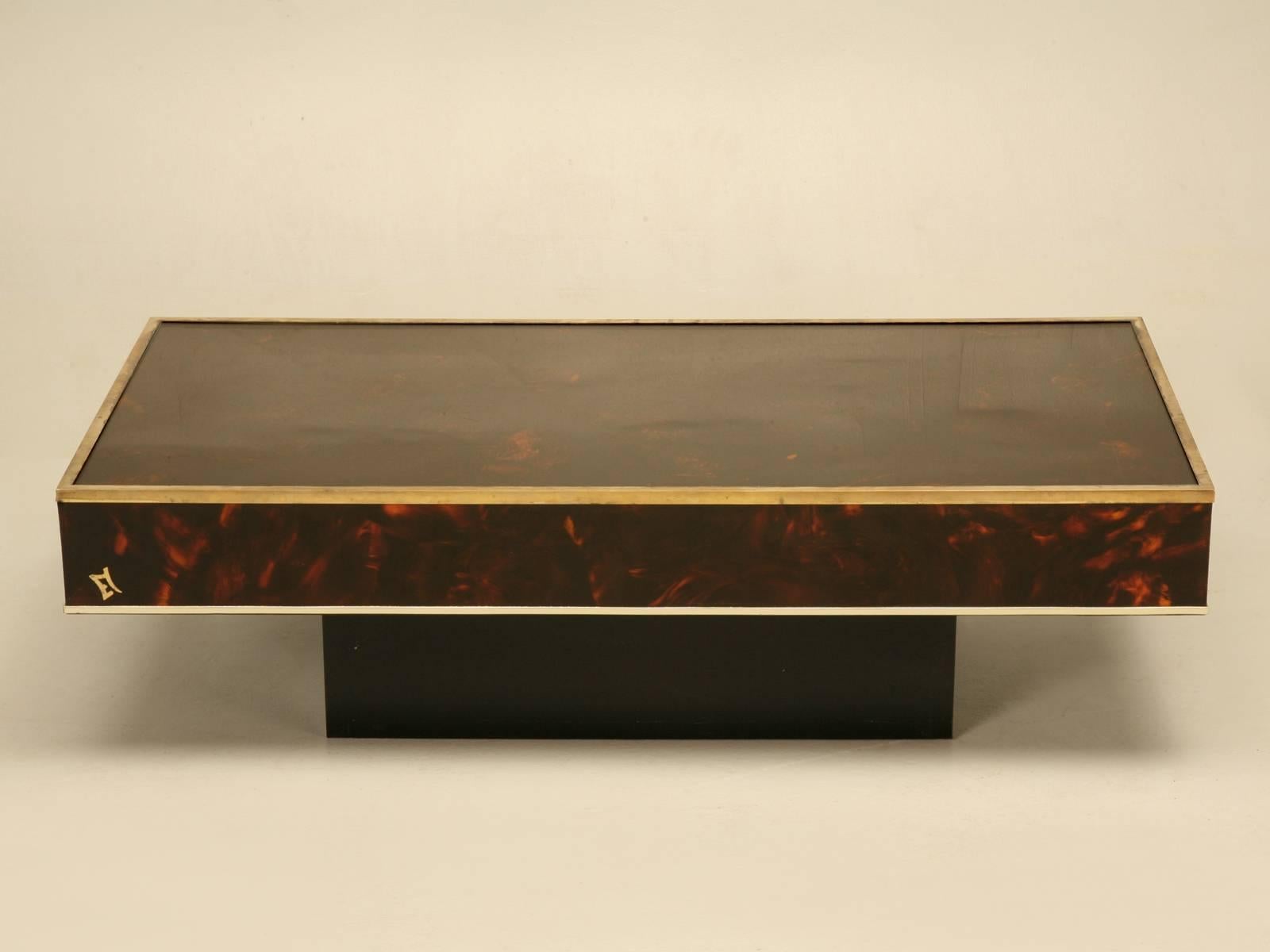 Great looking French Mid-Century Modern faux tortoise shell and brass coffee table probably made in the early 1970s. There are the normal light surface scratches on the surface that one would expect, but all in all, it is in quite nice condition and