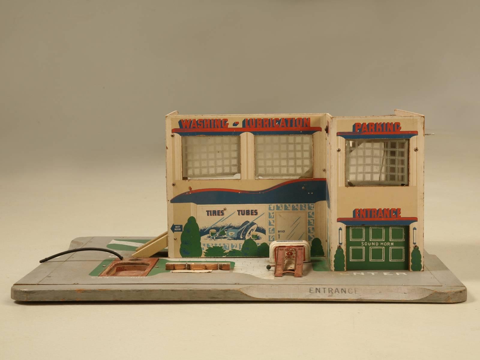 Children’s toy automotive garage probably made in the mid-1950s for a 1/43rd scale model car, such as those made by Tootsie, Dinky and Corgi among others which we also have available. Considering it’s how old it is and how it was used, this one