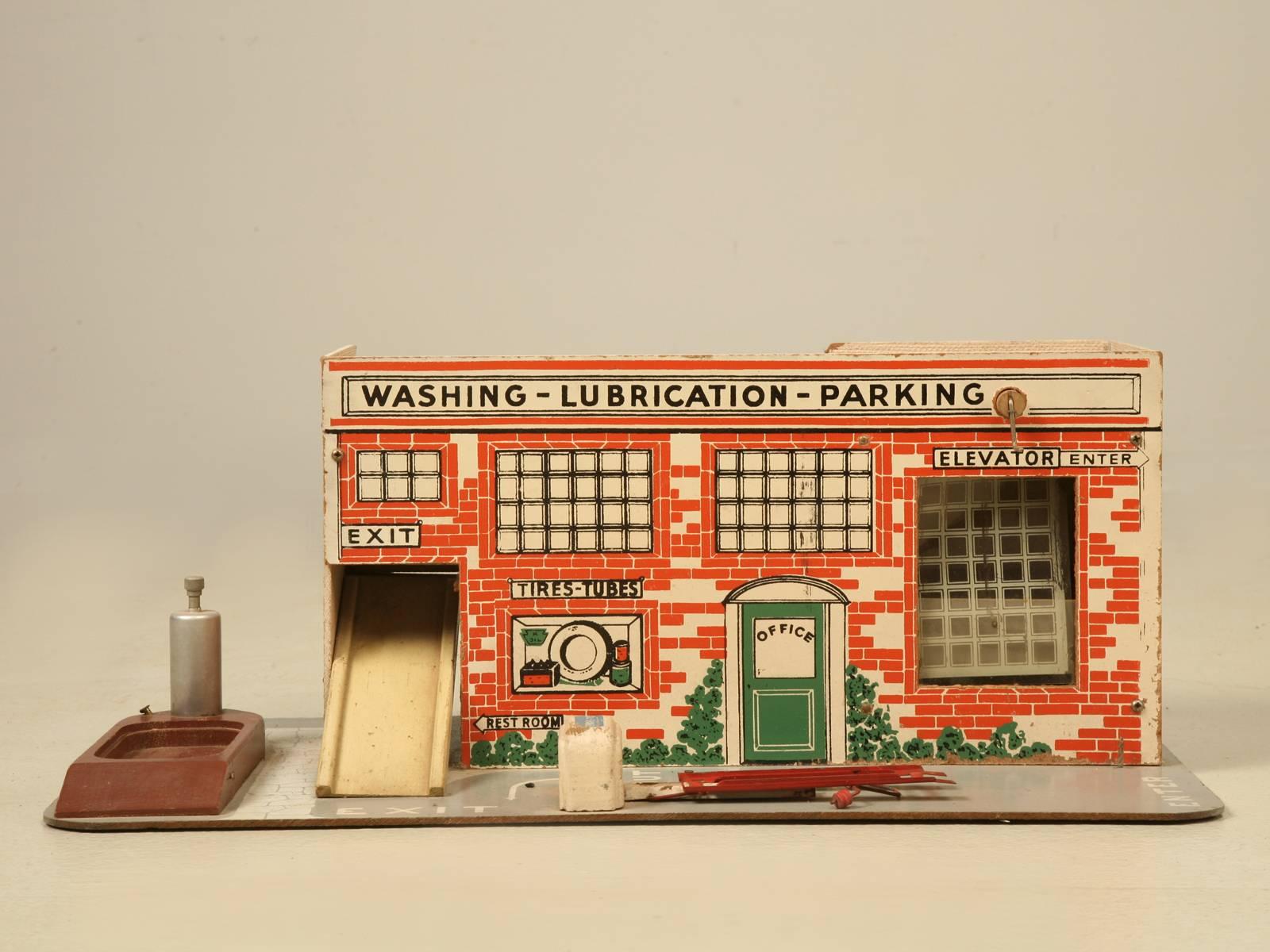 Vintage child’s toy garage probably made in the 1950s for a 1/43rd scale car, such as those made by Dinky and Corgi which we also have available. Considering its age and who used it, this one remains in pretty good all original condition. We do have
