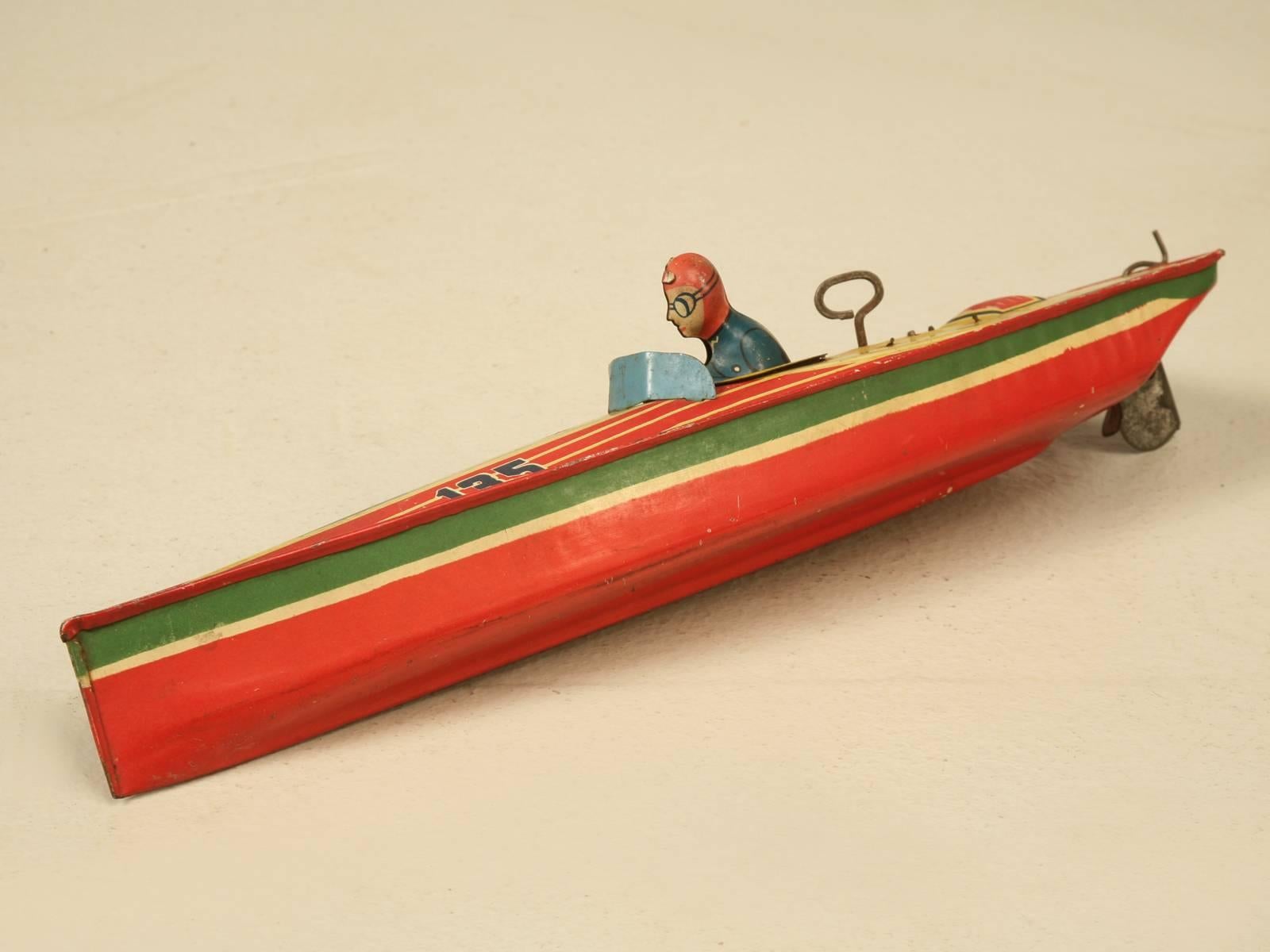 American Lindstrom tin windup boat made in the 1930s and in remarkable all original condition. The Lindstrom Tool & Toy Company from Bridgeport, Connecticut was founded in 1913 founded and they produced mechanical toys and games from pressed steel