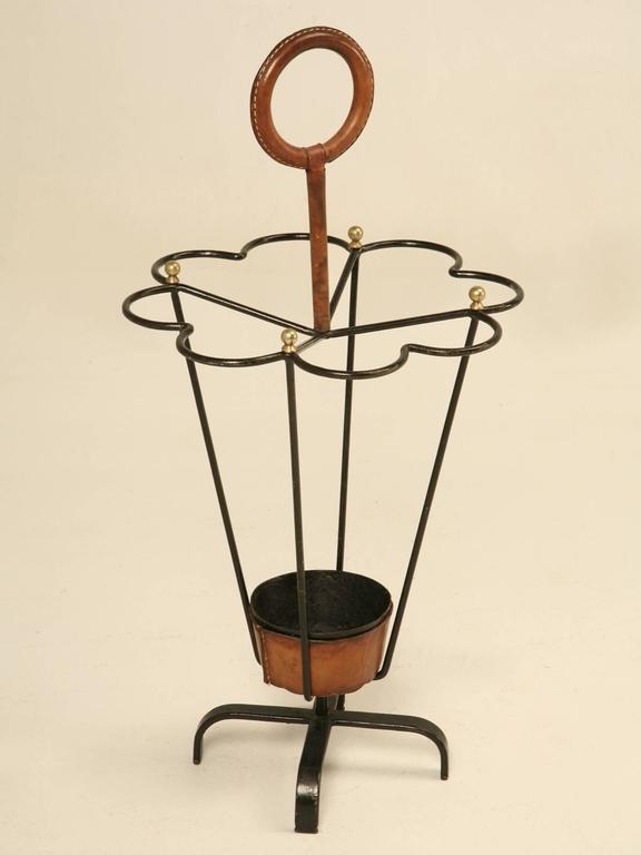 Original Jacques Adnet leather wrapped umbrella or stick stand.
Jacques Adnet was an iconic figure in French Modernism. He believed in function of the furniture blended with geometrical simplicity. In the 1950s he created furniture and concentrated