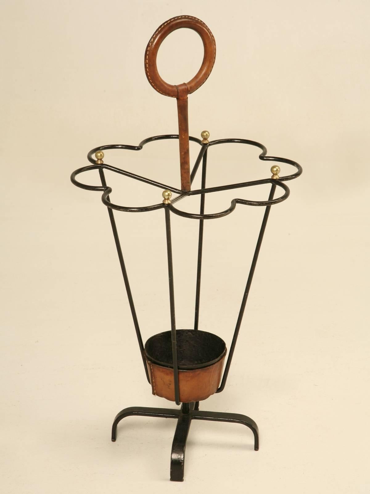 Original Jacques Adnet Leather Wrapped Umbrella Stand or Stick Stand.
Jacques Adnet was an iconic figure in French Modernism. He believed in function of the furniture blended with geometrical simplicity. In the 1950s he created furniture and