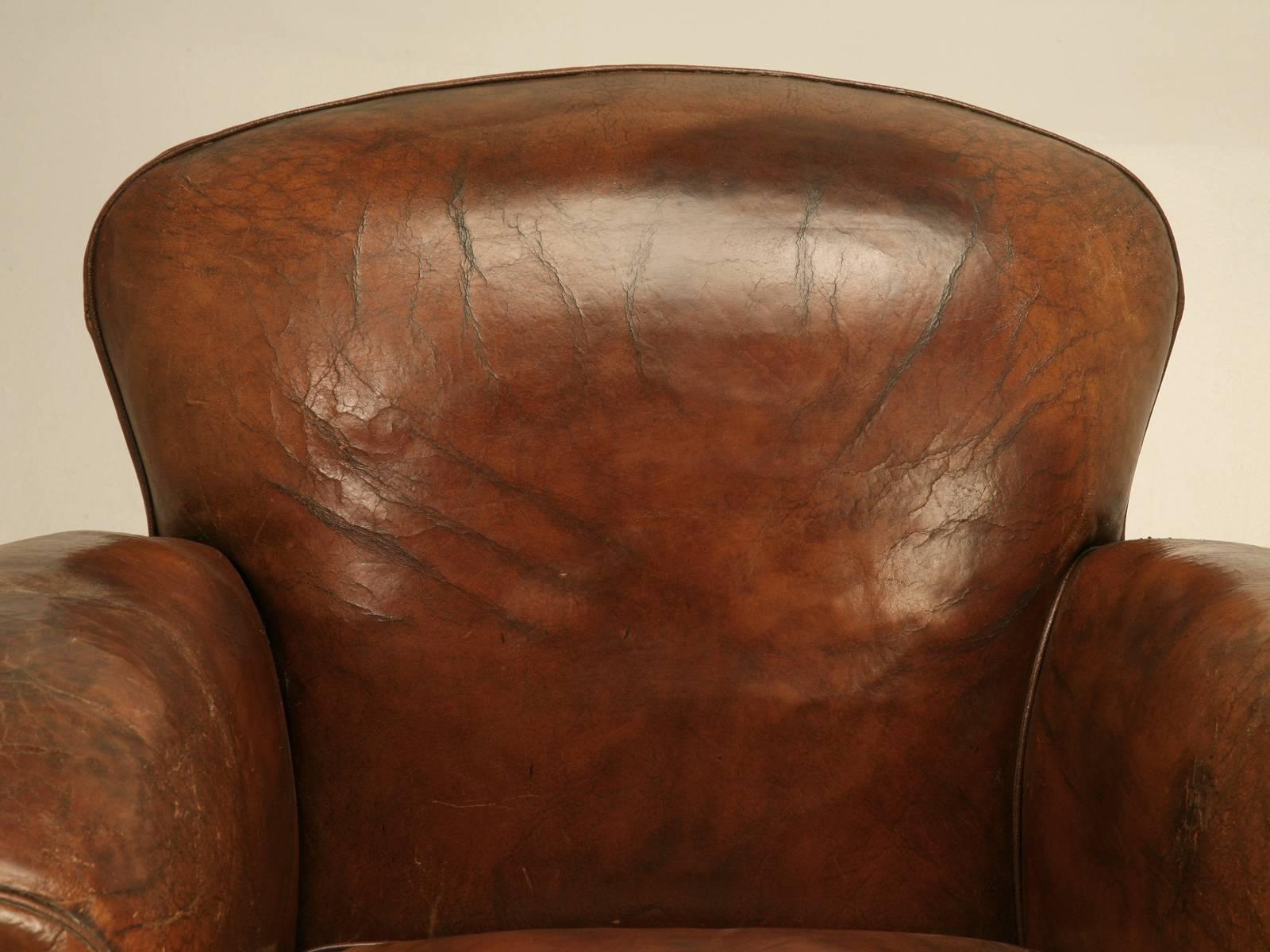 French Art Deco club chair from the 1930s still with its original leather that has been painstakingly restored from the bottom to the top. The inherent richness of the color of this old leather is something that you cannot duplicate and with it’s