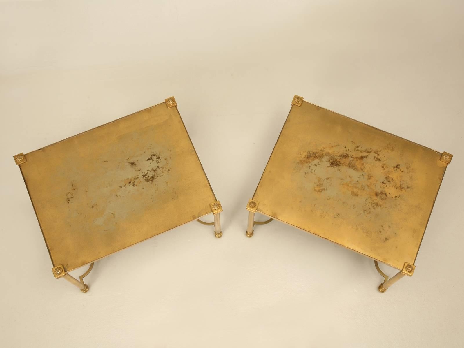 Pair of French Mid-Century Modern petite brass coffee tables in the style of Baguès, with a distressed gold patina glass top. These would also function just as easily as end tables that are always so difficult to find a good looking pair. The