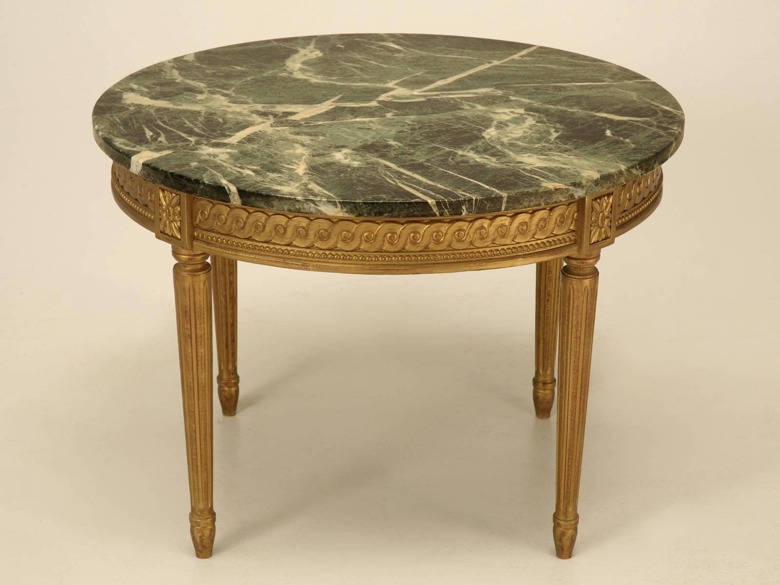 Unusual Louis XVI style gilded coffee table with a marble top in nice original unrestored condition.