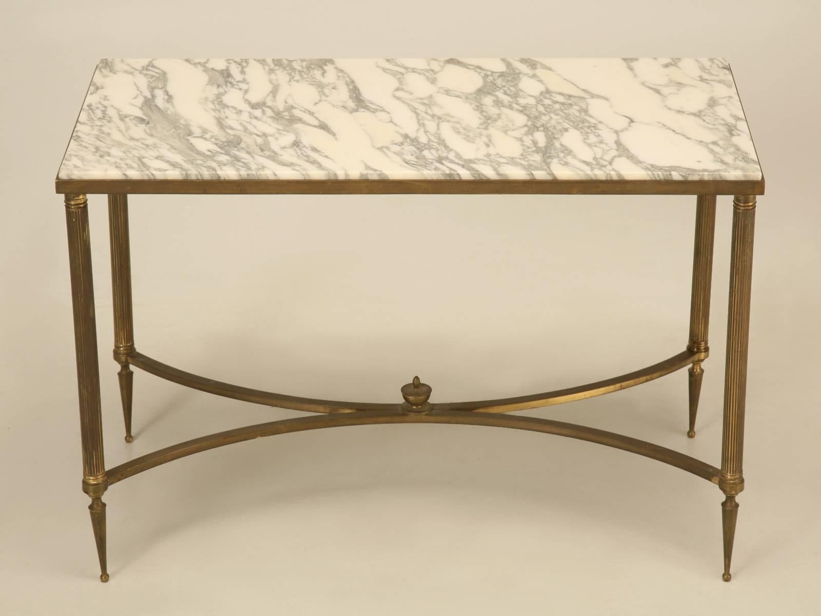 Vintage French Mid-Century Modern coffee table with a marble top over a brass-plated base in original unrestored condition.