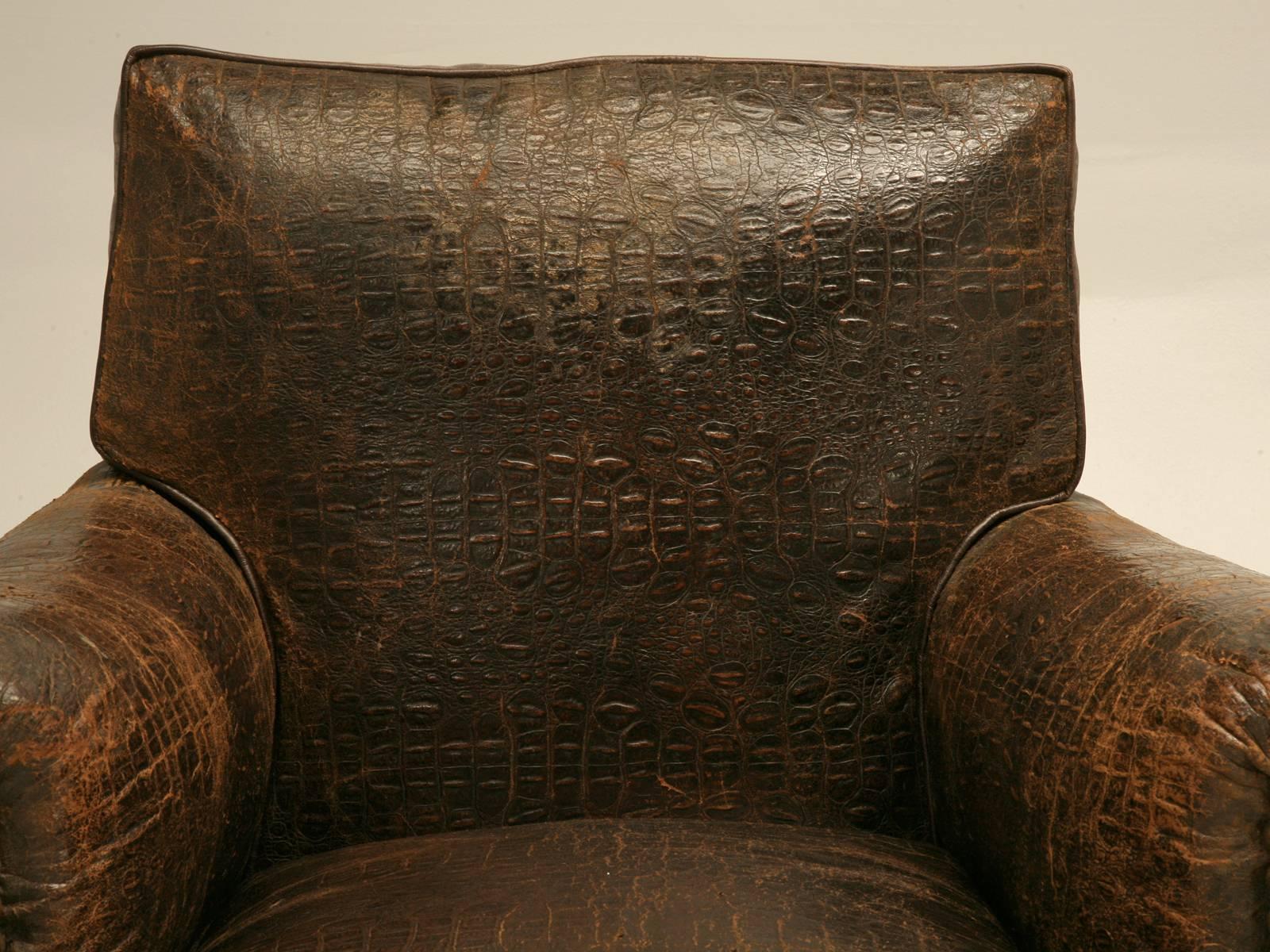 Beyond rare best describes this pair of original vintage French crocodile embossed leather club chairs, with the extremely desirable box shaped backs outlined with original nail head trim. In hunting for the very best French club chairs for the past