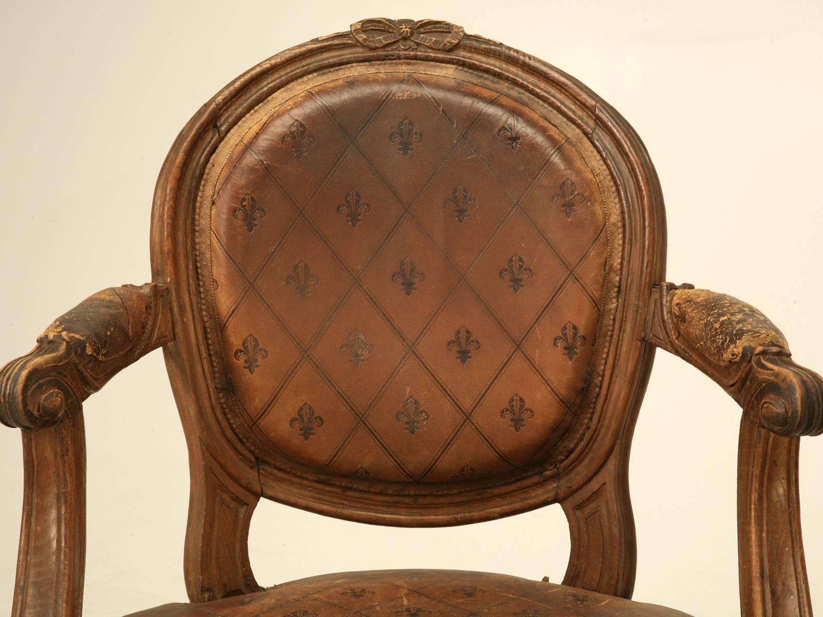 Great pair of very old French Louis XVI Armchairs, in their Original Leather upholstery. Although we do have an in house upholstery department, I have been resisting the temptation to change out the unusual pattern Leather and it is possible to