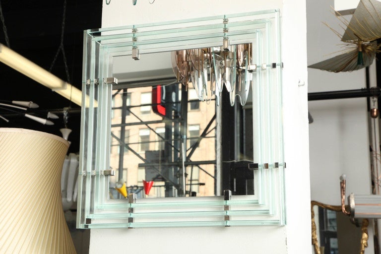 Stunning mirror designed by Roberto Giulio Rida made in Milan, 2013. Frame of mirror made up of hand-cut-glass bars fixed to the mirror with beautifully made chrome fittings, signed.
 