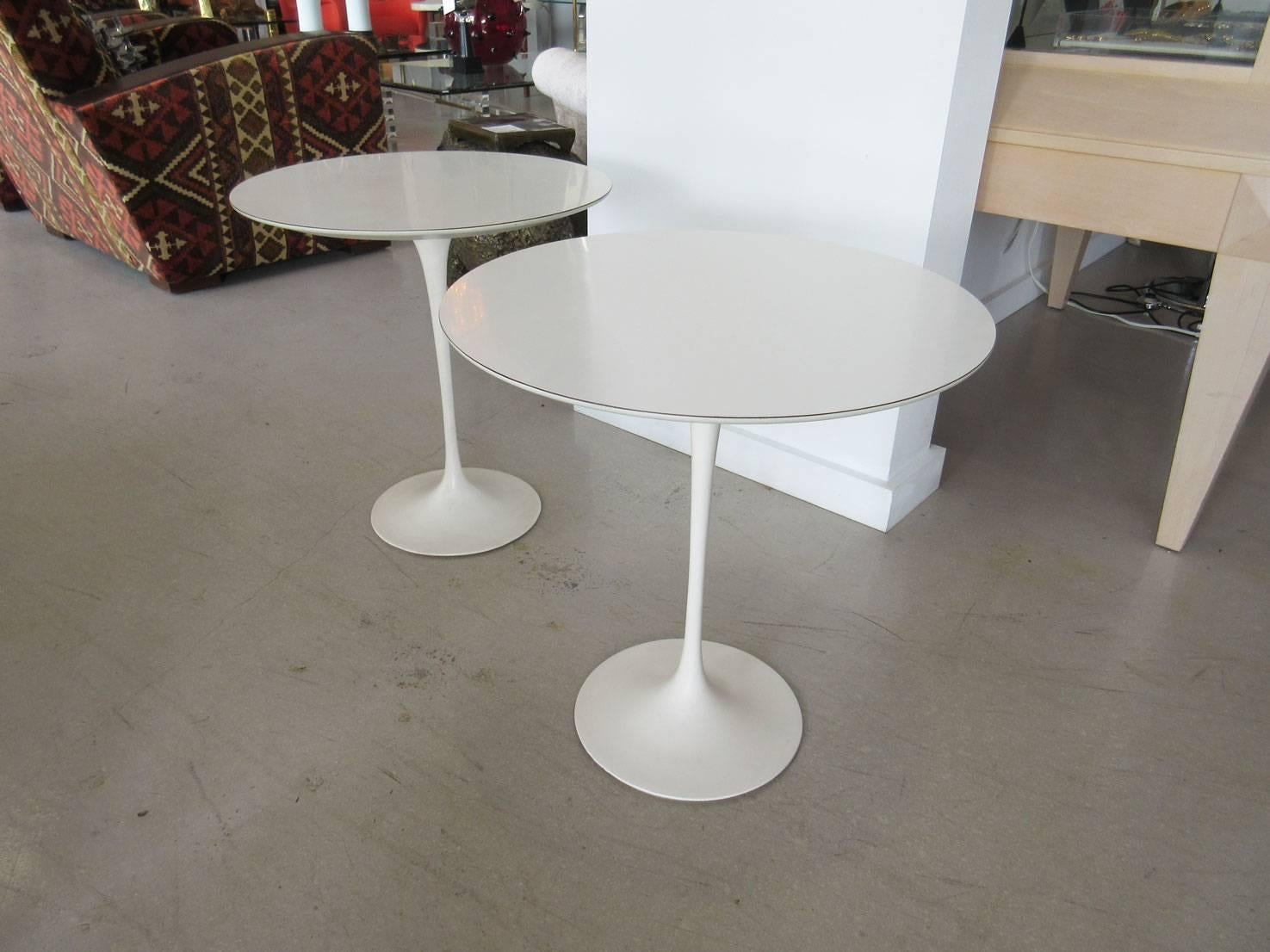 Pair of original Knoll tulip tables with circular tops designed by Saarinen. The tables have original labels on verso.