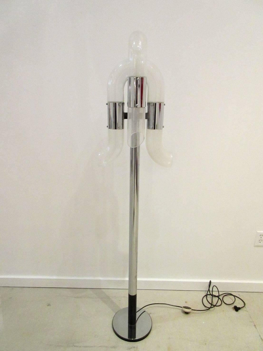 Mid-Century Modern tubular chrome standing lamp with white glass elements.