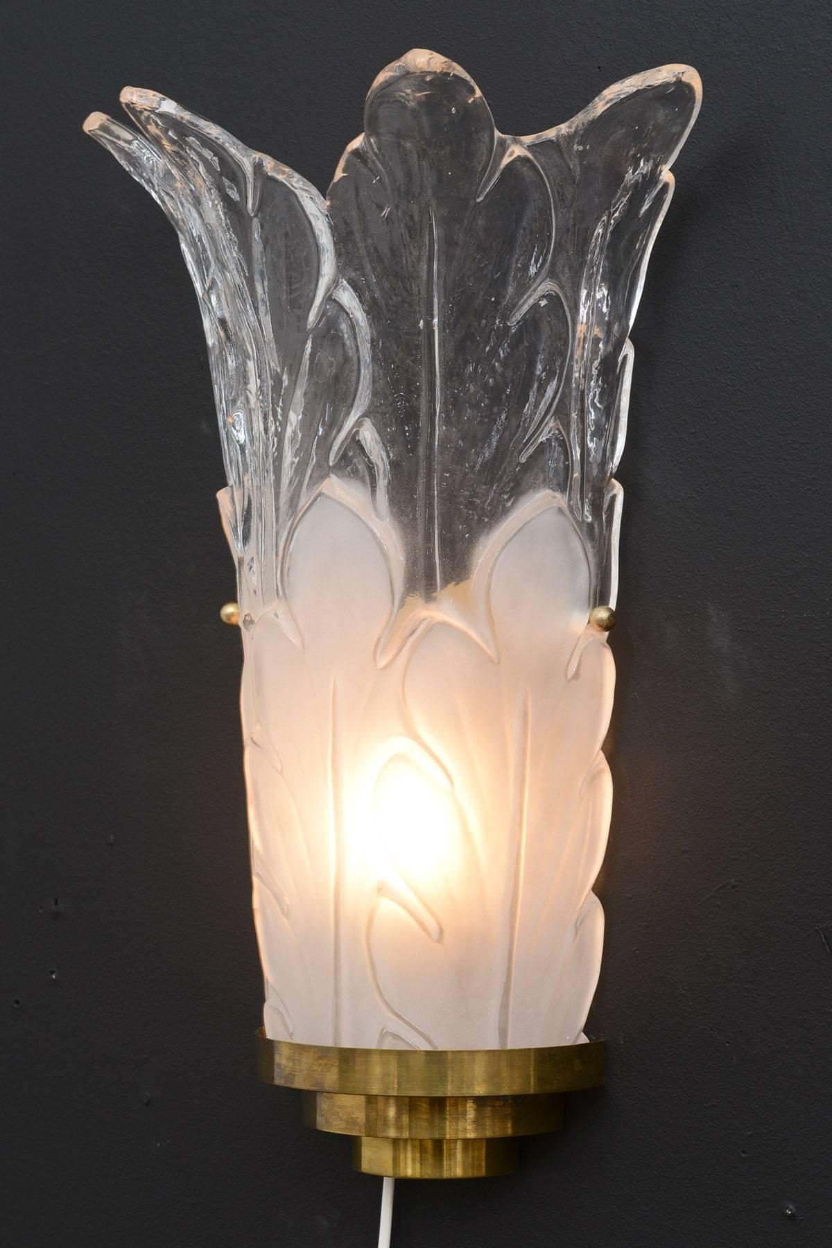 Pair of Italian Deco style sconces with clear and frosted glass shades depicting leaves; brass frame.