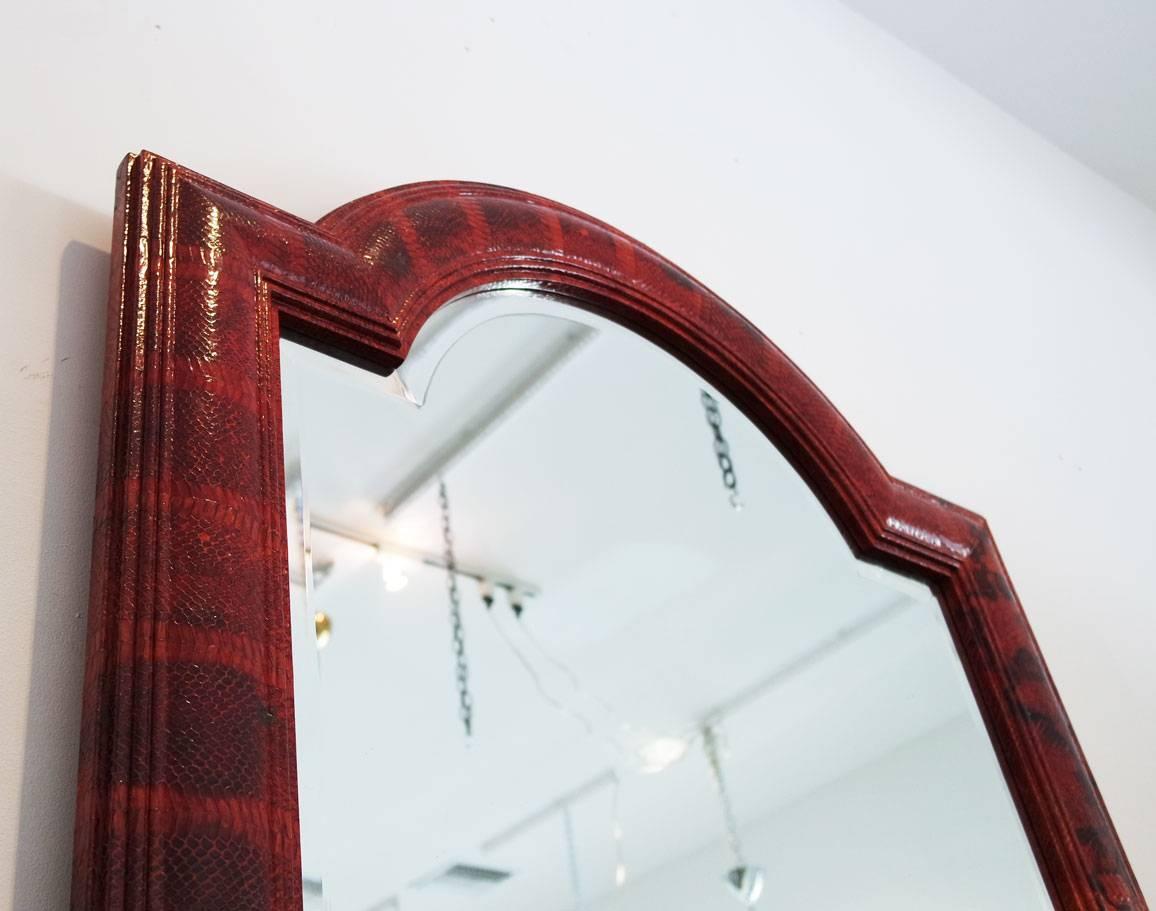 Large red python mirror by Karl Springer.