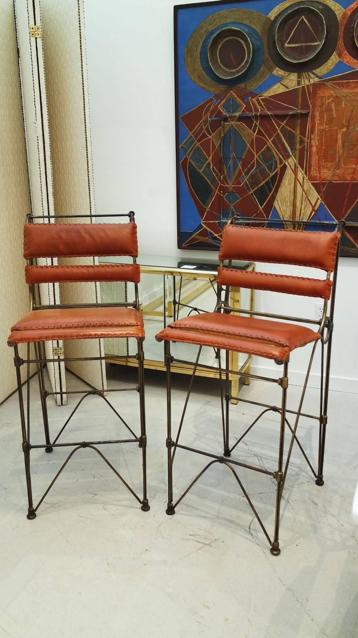 Pair of industrial leather and iron barstools by Ilan Goor. Measures: Seat height 28.