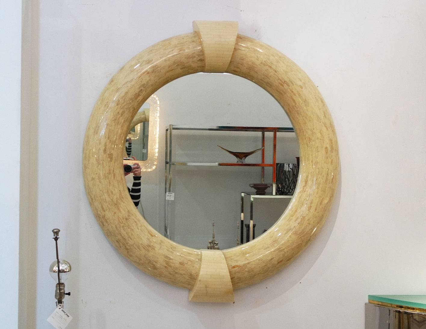 Large circular Karl Springer mirror with two bone veneer keystones.