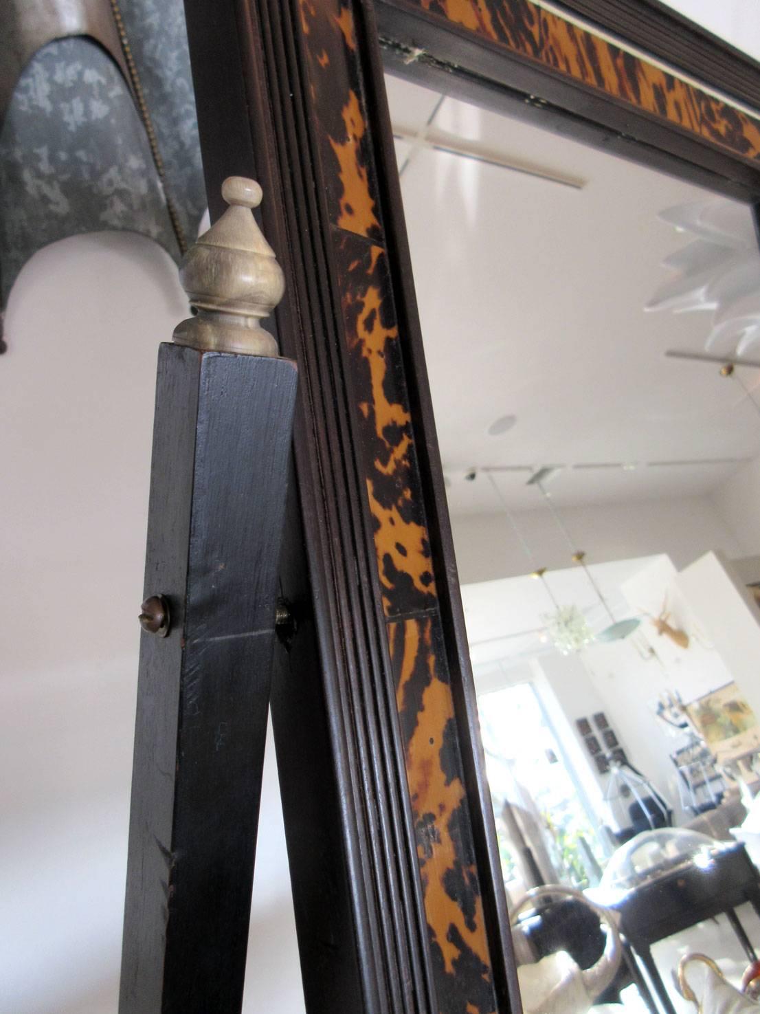 Turn of the century gentleman's mirror with tortoise shell inlay. The mirror pivots and has one pull out drawer.