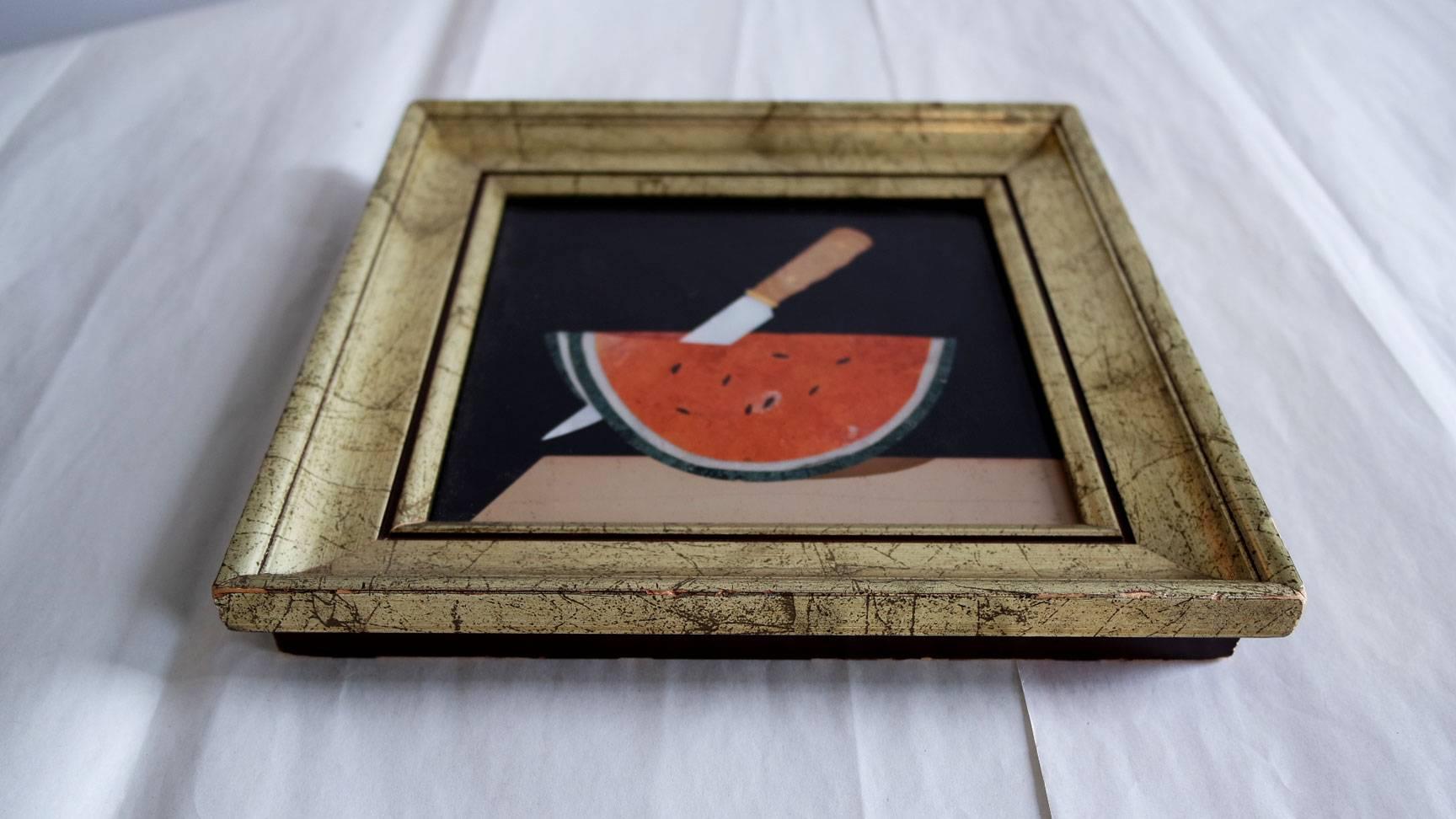 Vintage framed Pietra Dura depicting a watermelon on a cutting board being sliced by a knife.