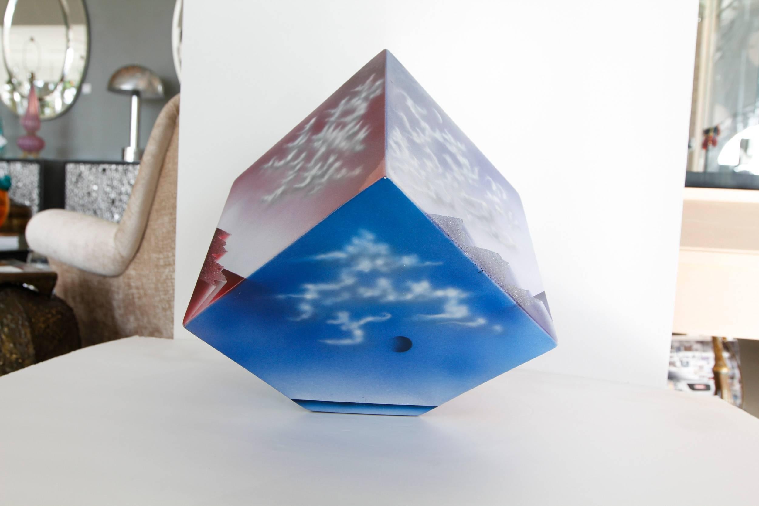 Artist made ceramic cube sculpture with atmospheric images of clouds artist unknown.