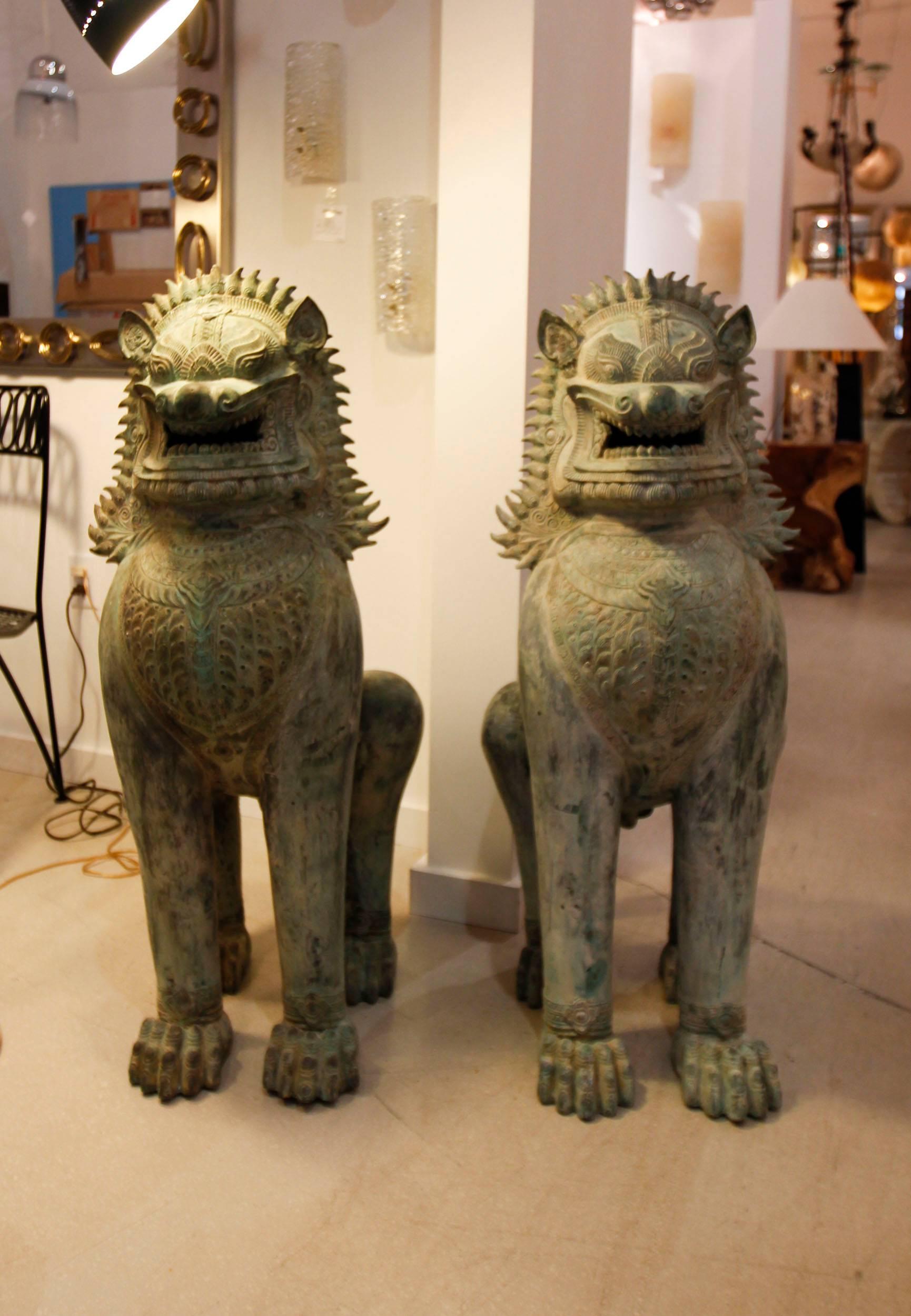 Pair of large and expressionistic Asian bronze foo dogs.