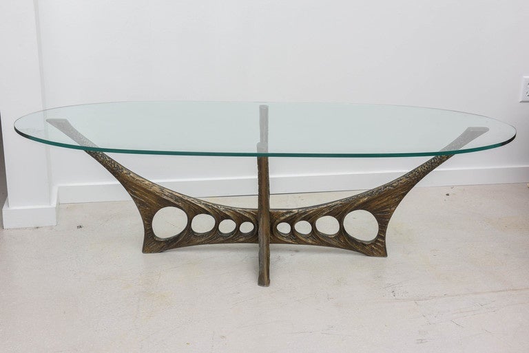 Large French Brutalist metal coffee table with a new oval glass top.