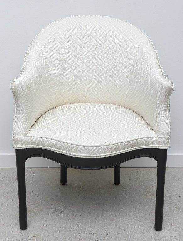 Pair of Hollywood Regency armchairs, newly upholstered in a white patterned fabric with Greek key motif and the legs are lacquered black.