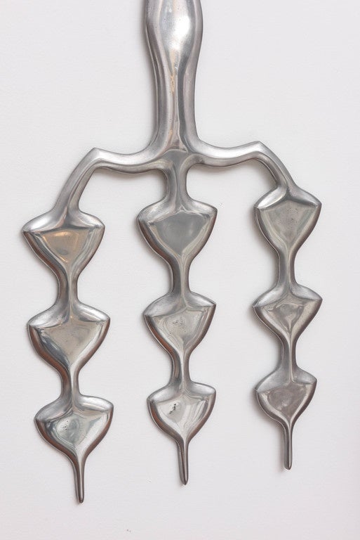 Monumental American aluminum wall-mounted sculpture in an abstract tribal motif. The sculpture is in the manner of Donald Drumm.