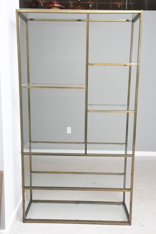 Single bronze Milo Baughman etagere with glass shelves.