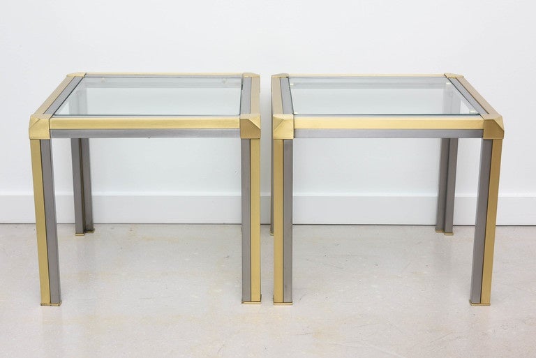 Pair of brass and steel two-tone geometric side tables with inset glass tops. The tables have been professionally polished.