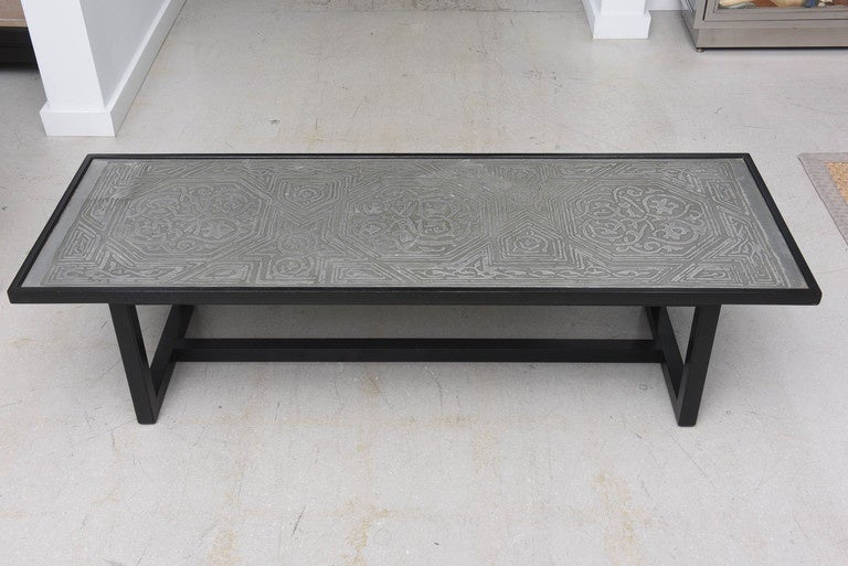 Mid-Century Modern French coffee table with ebonized wood and etched metal abstract motif top.