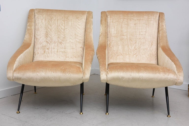 Pair of 1960s Italian chairs with black metal and brass tapered legs. Newly upholstered in a champagne color velvet.