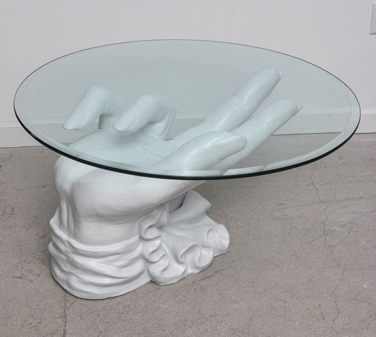 Sculptural white plaster coffee table the hand is in the style of John Dickinson with circular glass top.