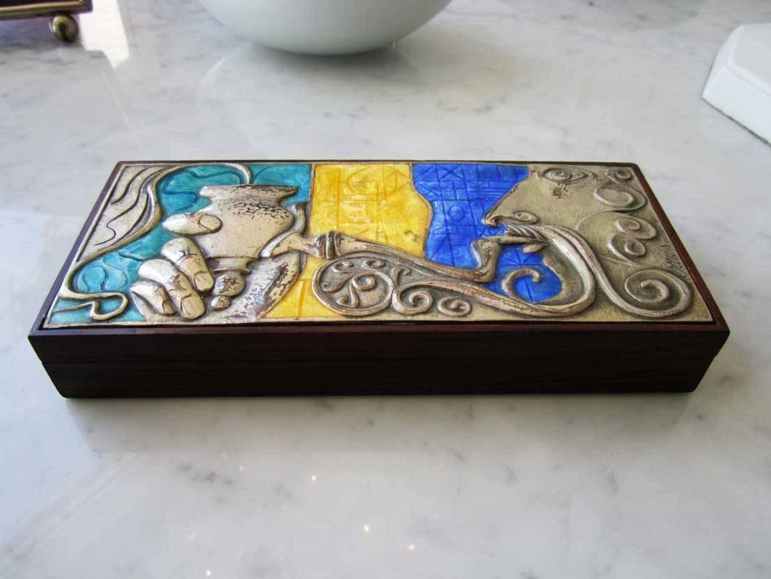 Brightly colored enamel and sterling silver box made by Italian workshop Ottaviani featuring an image of a man smoking a pipe.