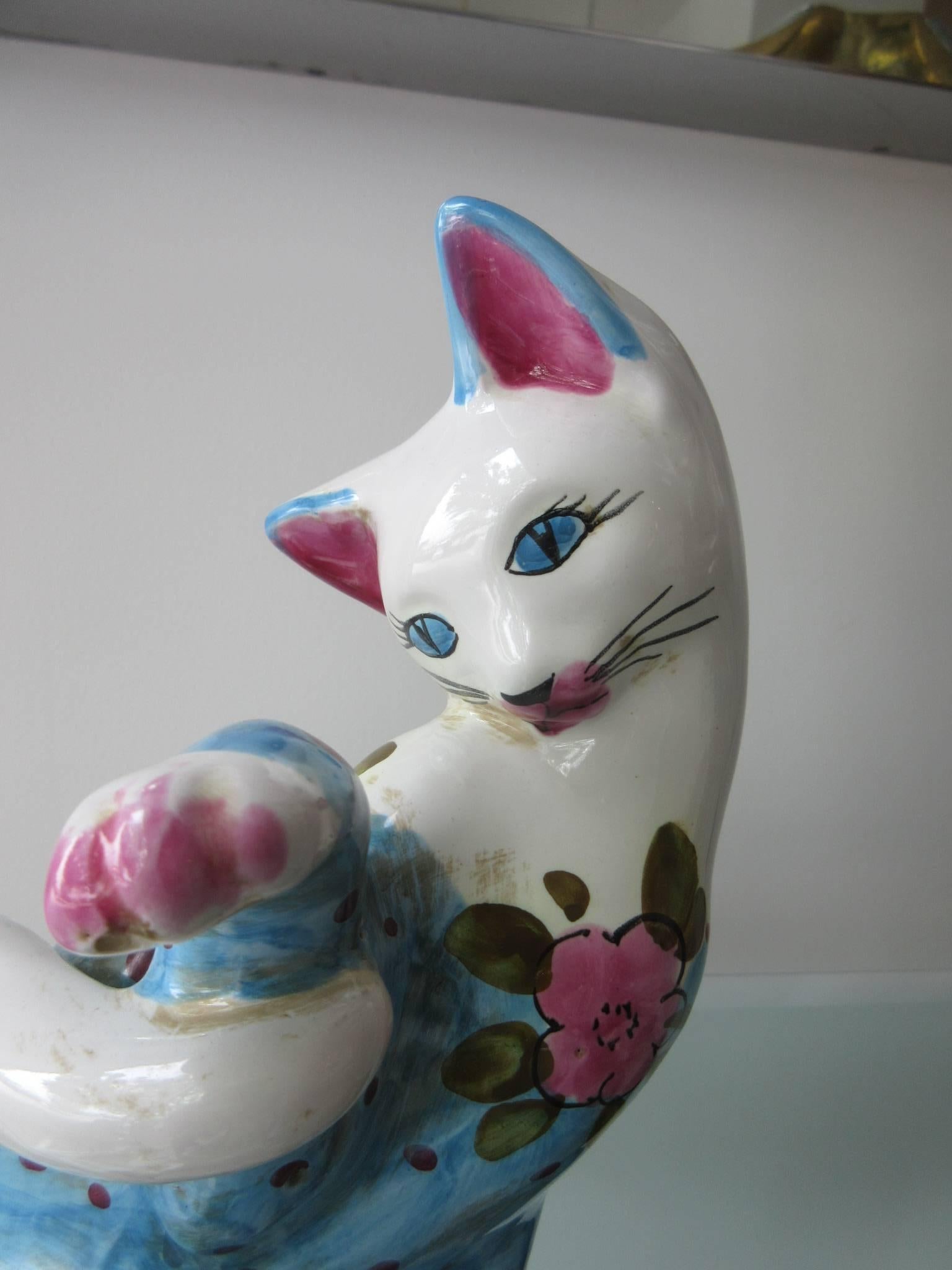 Vintage Italian glazed ceramic cat (Smaller) handmade in Italy in the style of Fornasetti. The palette is pink, blue and white. We have the larger compatible cat in another listing. Be sure to see them together. 

