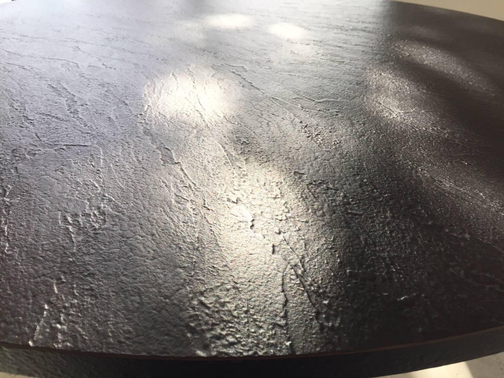 Dramatic linear painted steel center table by Woodard-- may be used as dining table. The circular top is faux slate.