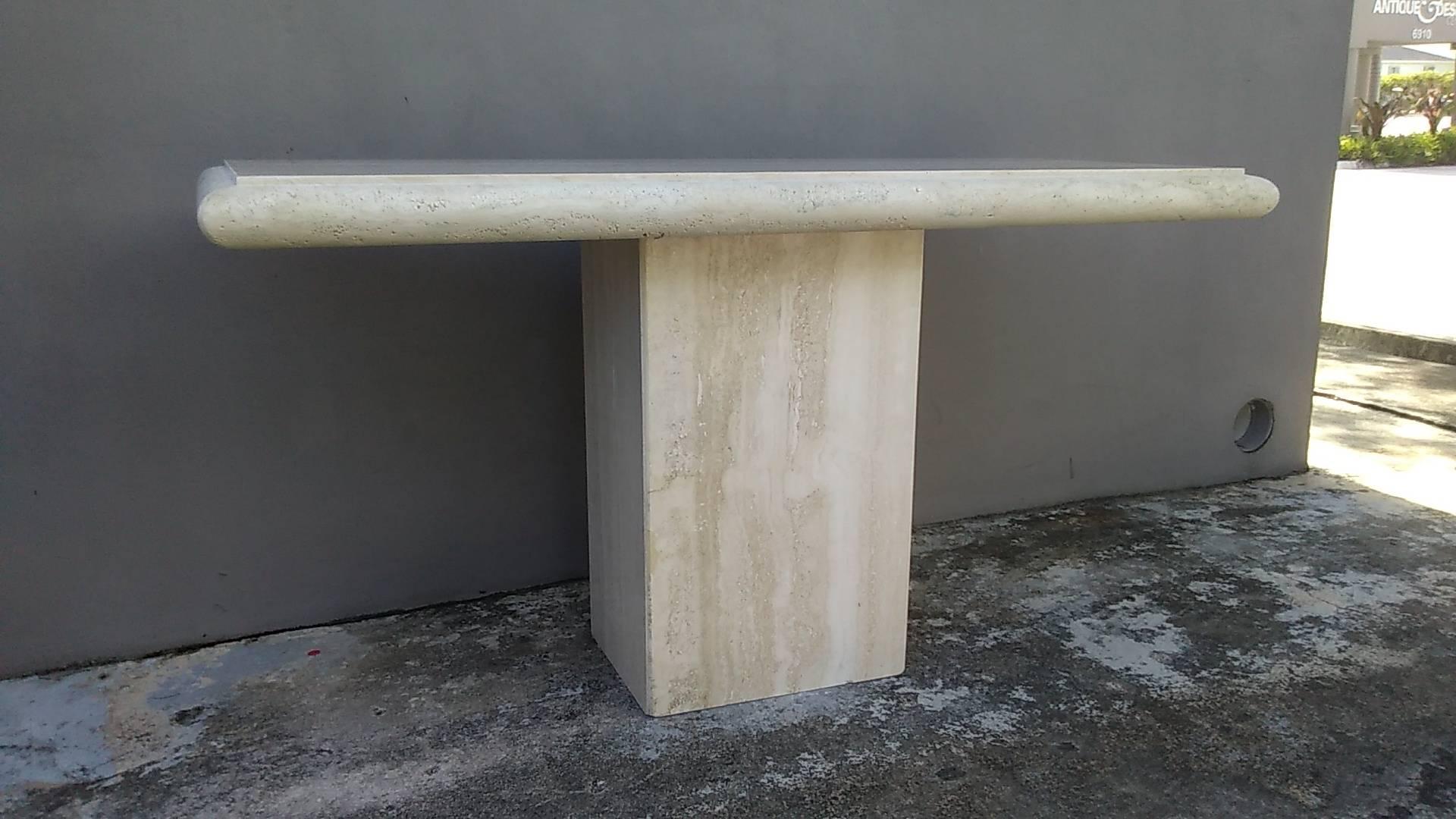 Travertine console table made in Italy by Stone International for Ello. The console is two pieces. The original label is retained on underside.