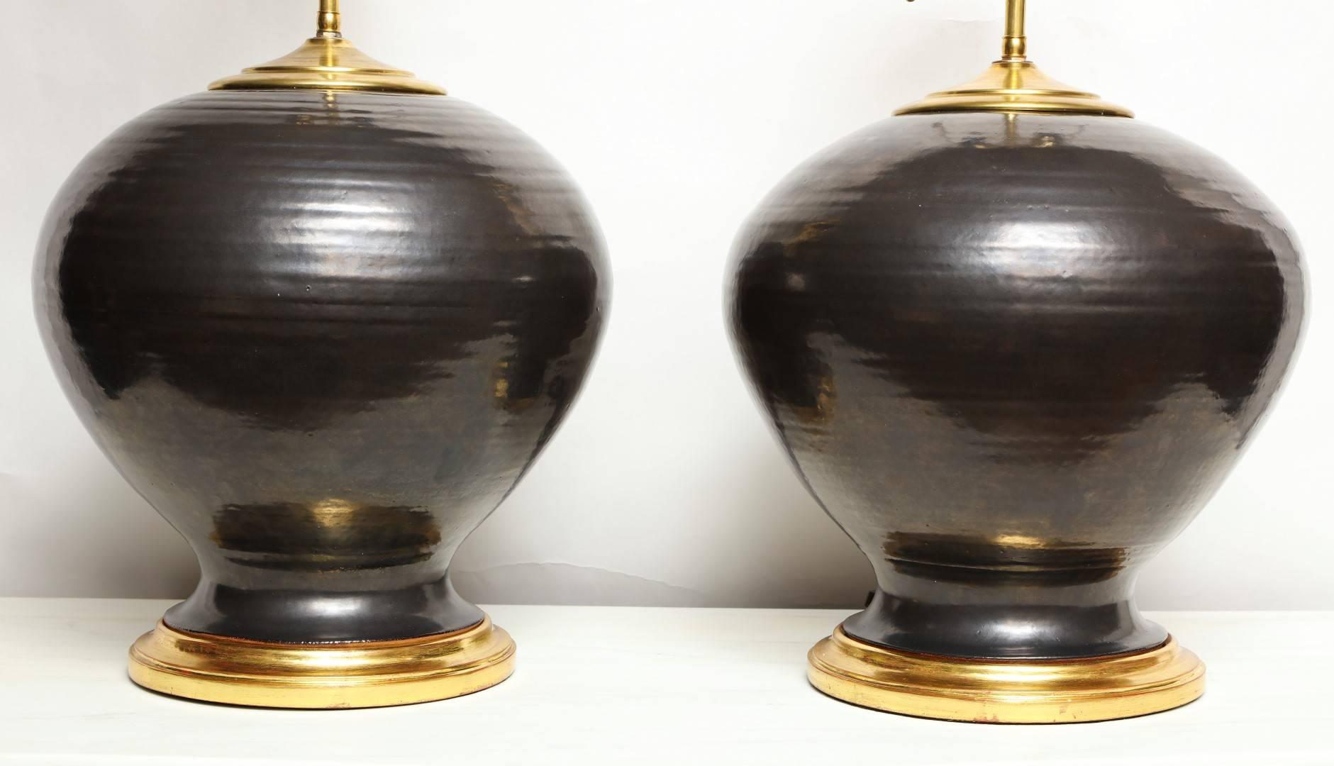 A pair of signed hand-thrown American ceramic studio vases with ribbed texture, the tapered shape with 5