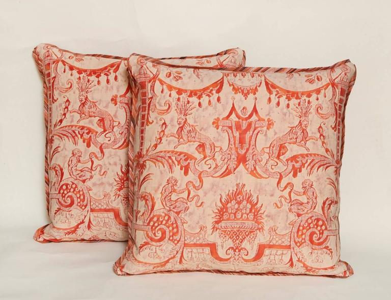 A pair of vintage Fortuny fabric cushions in the Mazzarino pattern, in a bittersweet and ivory colorway with striped silk bias edging and back, the pattern, a 17th century French design named for the famous cardinal at the Court of Louis XVIII and