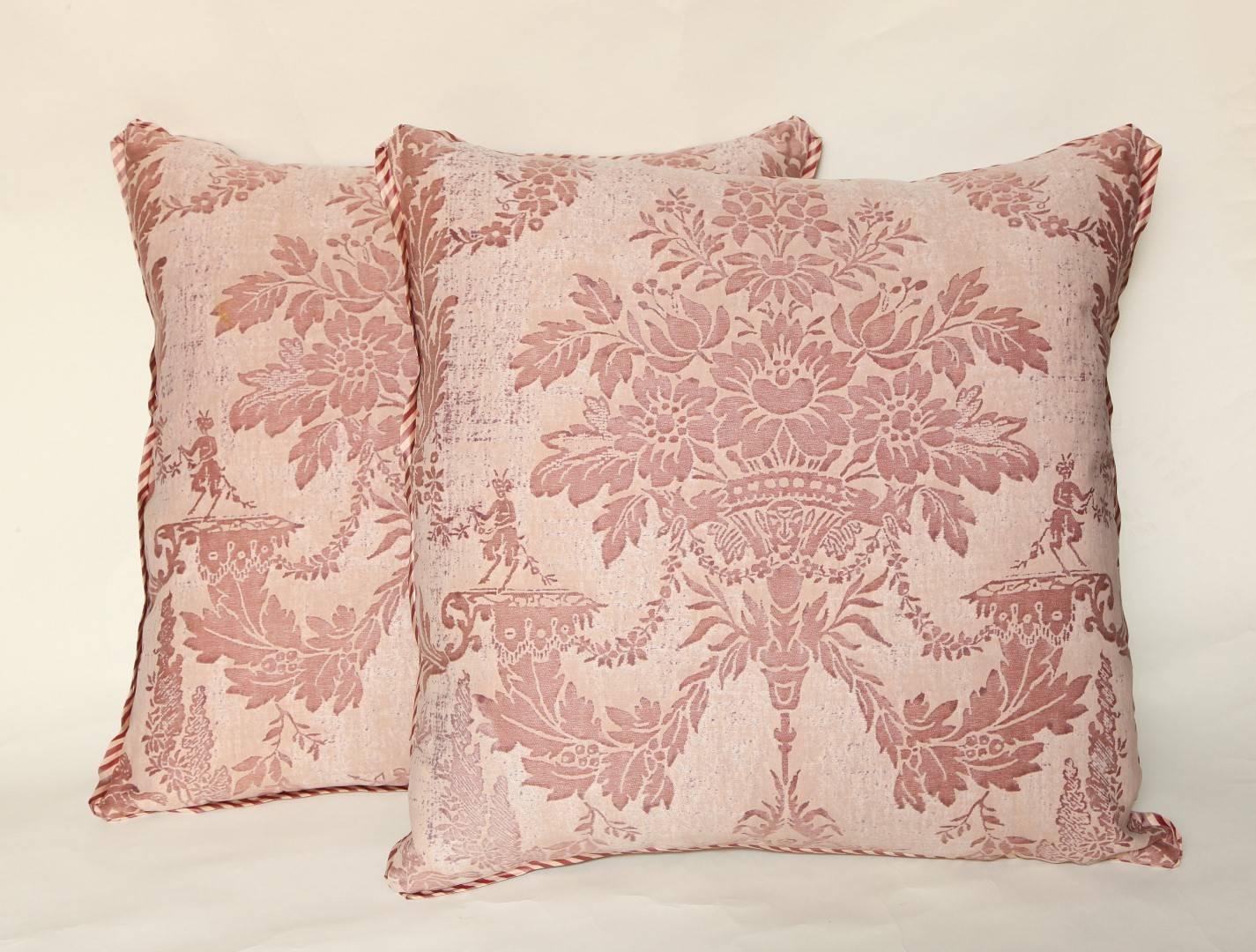 A pair of vintage Fortuny cushions in the Boucher pattern, beige and rose color way with bias silk striped edging and raw silk back, the Boucher pattern named for the most celebrated painter and decorative artist of the 18th century, Francois