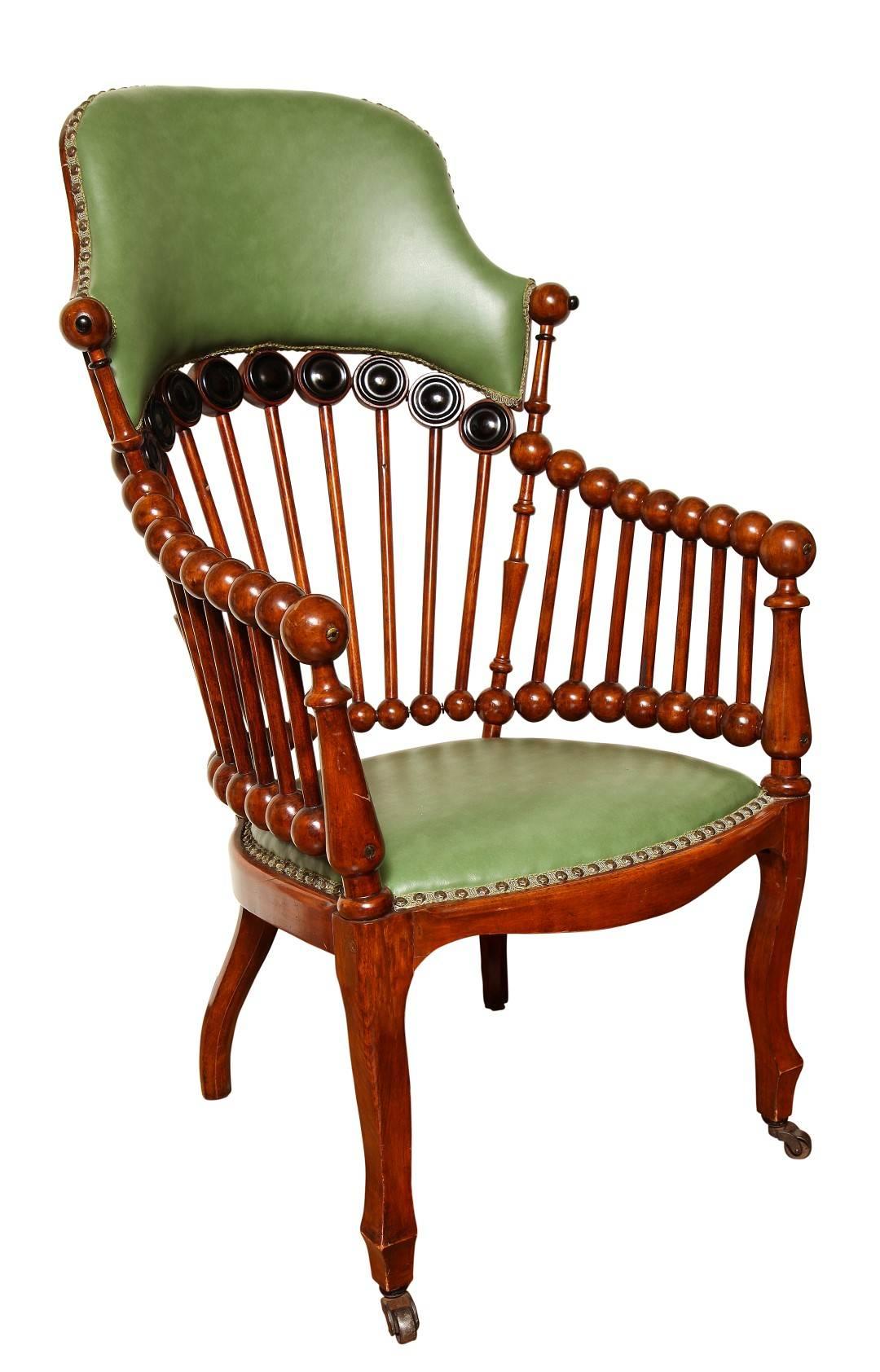 A green upholstered armchair and a green upholstered rocking chair by Hunzinger in signature 