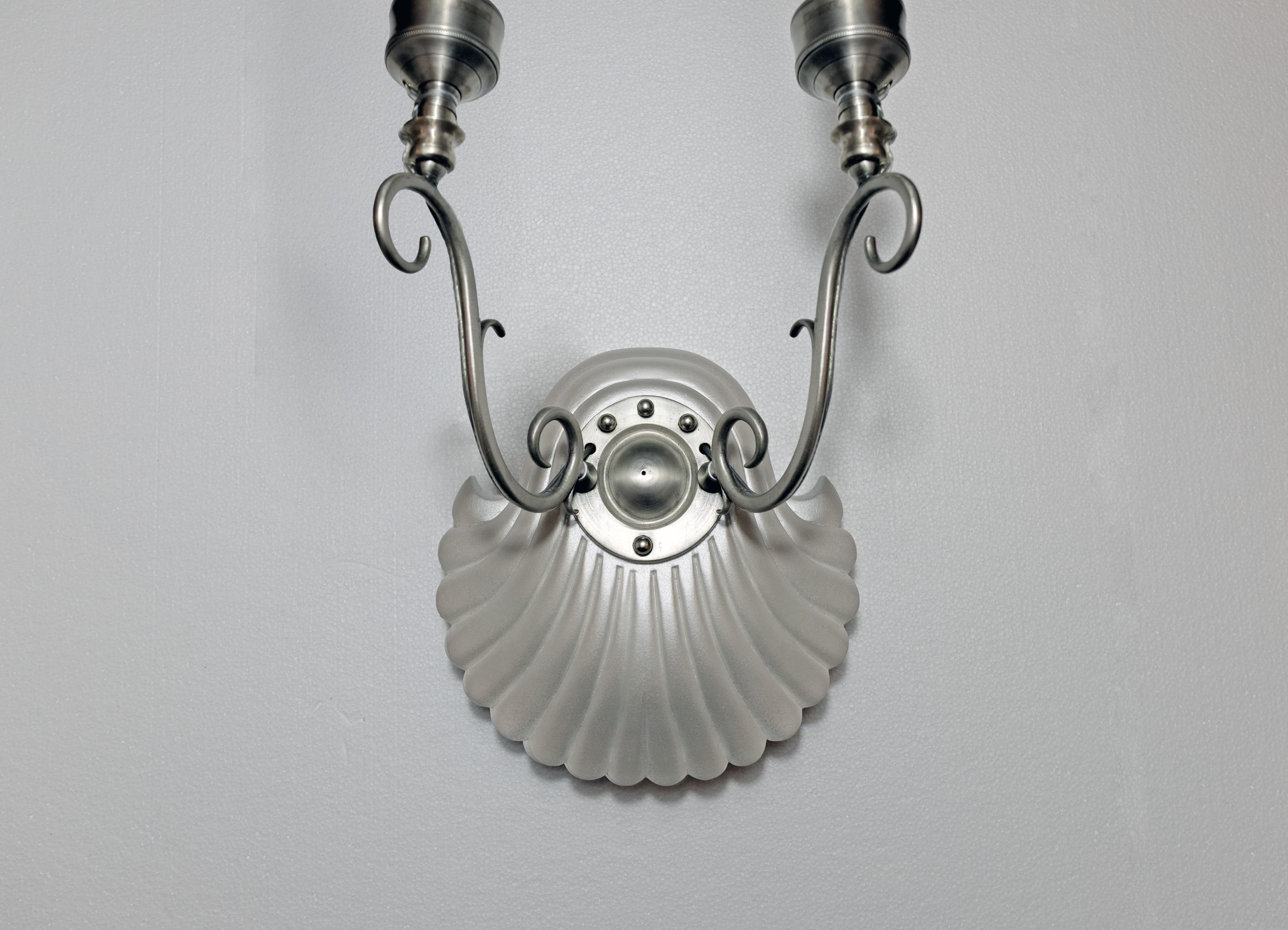A pair of Coquille sconces by David Duncan Studio. The hand-carved, shell-form backplates with a pearly mica powder finish. The etched pink shades supported by brass arms with silver patina. Available in custom finishes and shade colors. 