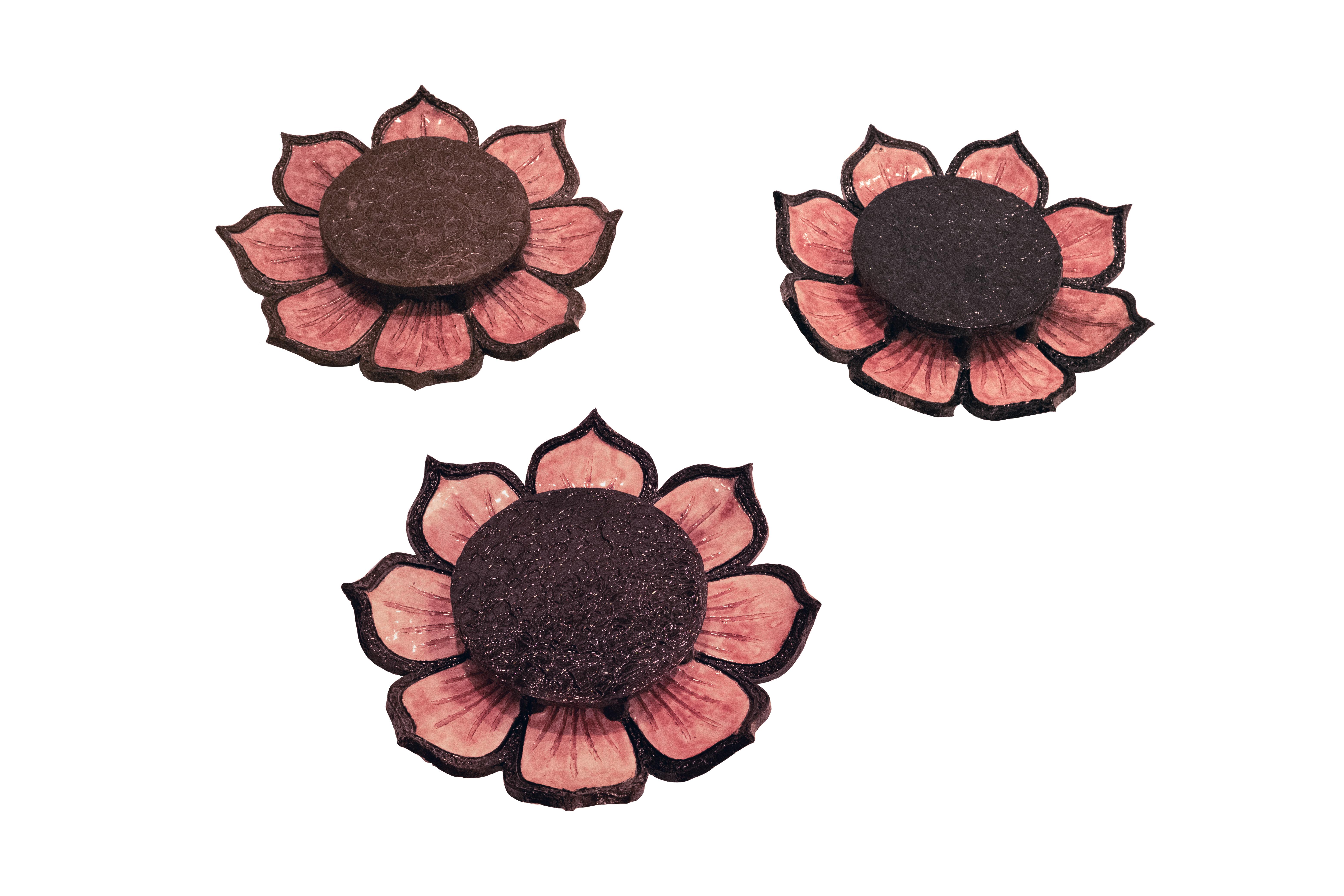 A set of three stoneware wall lights in the form of flowers with pink glazed petals. The inside fitted with two new UL sockets with a maximum wattage of 60 watts LED. Can be priced upon request to have mounted as a flush mount. Circa 1970. Priced