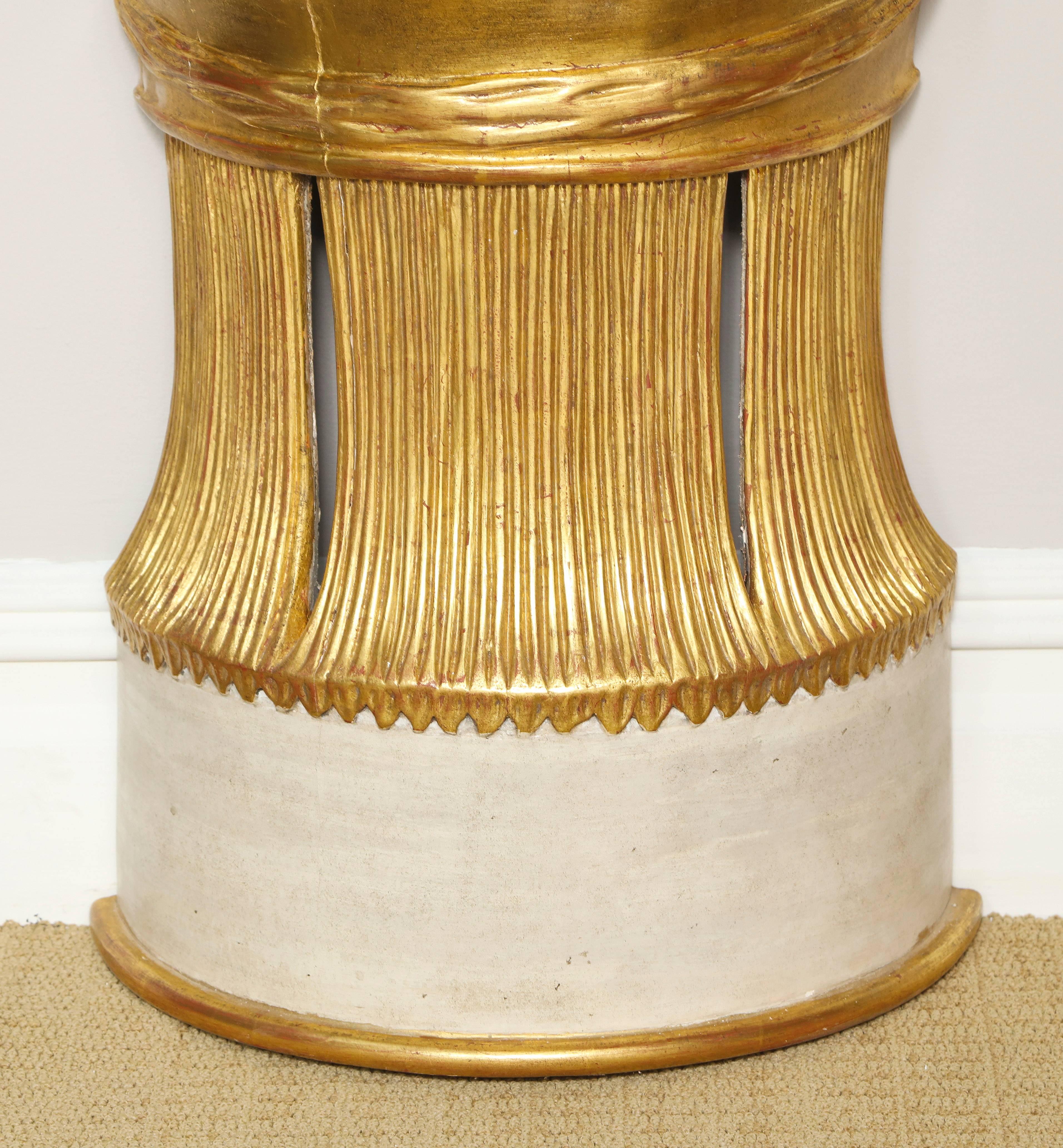 A Serge Roche style demi-lune giltwood console with mirrored top, the base is in the form of a splayed sheaf of wheat and is hand-carved in wood and gilt with contrasting white painted reserves. The top has recessed antique mirrored surface and the