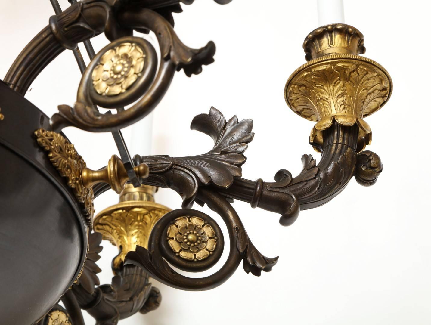 A French Empire Patinated Bronze and Gold Doré Eight-Light Chandelier In Excellent Condition In New York, NY