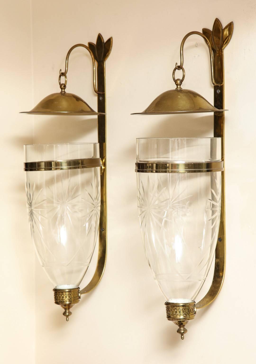 A pair of Georgian style wall lanterns with hand cut-glass hurricane globes having starbust motif, price includes non UL wiring with a single Edison socket.