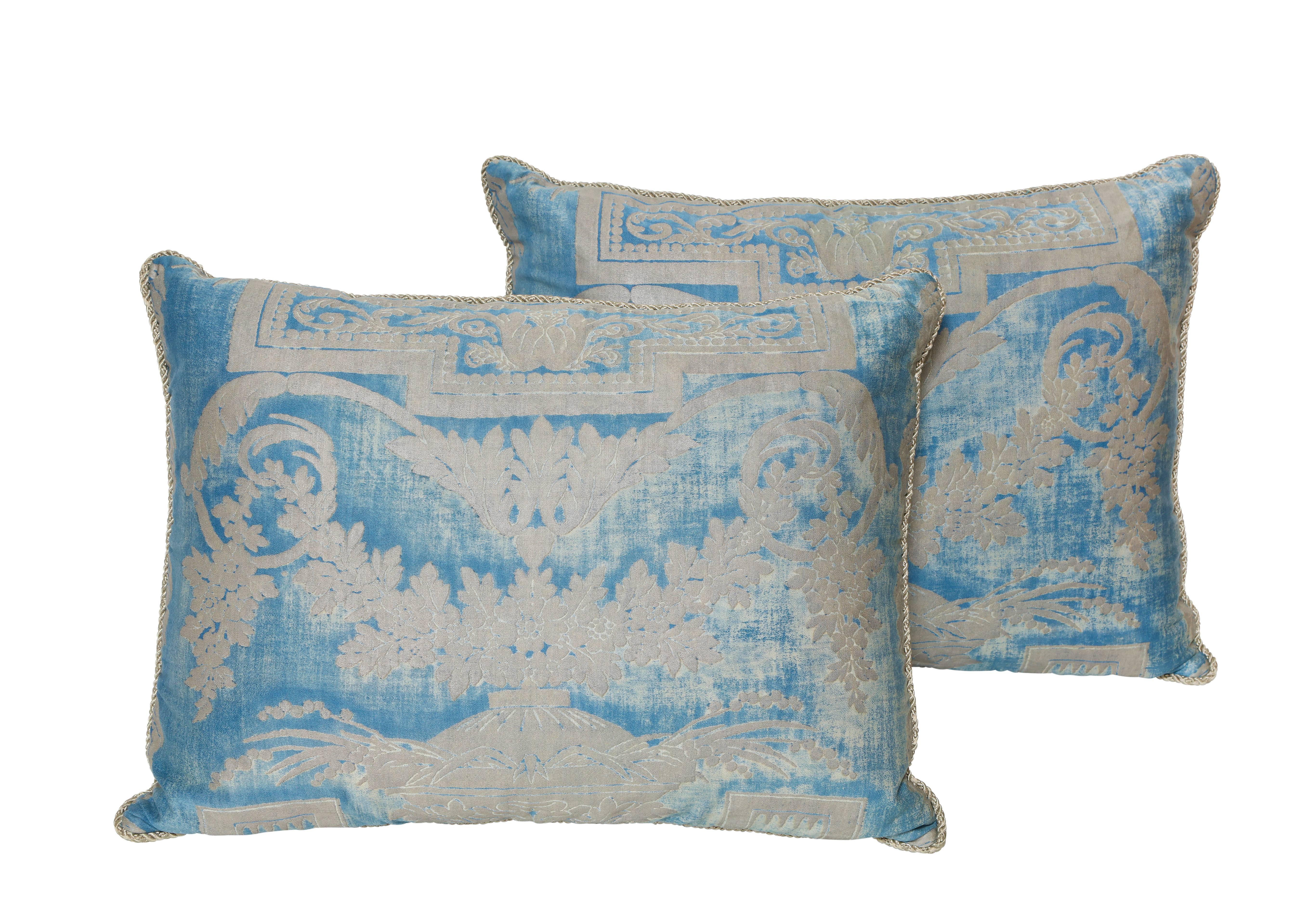 A set of three Fortuny silk pillow cushions in metallic blue and silver fabric depicting a neoclassical design with a draped garland motif, with braided trim and woven back
50 down/50 feather insert
Newly made using vintage Fortuny fabric, circa