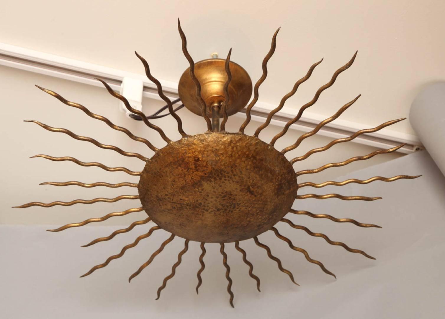 A newly made gilt metal sunburst fixture with two Edison sockets concealed by round centre. Multiple available. Based off of a Mid-Century Italian model.